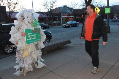 man confronts trash bag monster