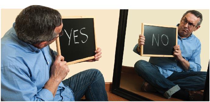 man holding yes sign looking at mirror