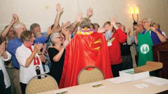 Ann Hoyt, disguised as Superwoman, draws the cheers of the crowd.